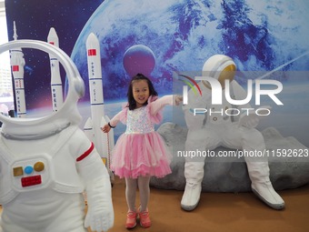 A child plays a game in the space experience area during the 2024 National Science Popularization Day in Beijing, China, on September 21, 20...