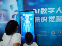 A child talks with an AI digital human at the 2024 National Science Popularization Day in Beijing, China, on September 21, 2024. (