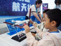 A child experiences a model of the ''Tiangong Space Station'' during the 2024 National Science Popularization Day in Beijing, China, on Sept...