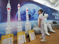 A child looks at a model of the Long March rocket during the 2024 National Science Popularization Day in Beijing, China, on September 21, 20...