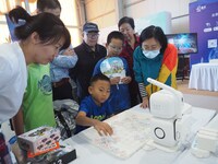 A child plays with a chess robot during the 2024 National Science Popularization Day in Beijing, China, on September 21, 2024. (