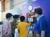 A child takes an AI photo during the 2024 National Science Popularization Day in Beijing, China, on September 21, 2024. (