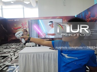 A child experiences a ''VR game'' during the 2024 National Science Popularization Day in Beijing, China, on September 21, 2024. (