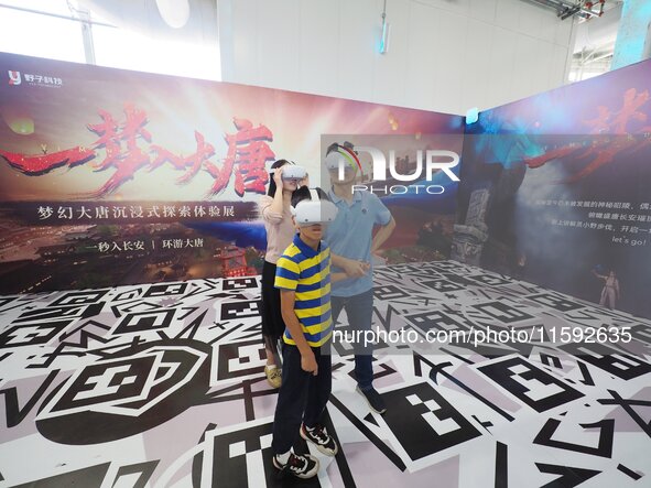 Visitors have a VR immersive movie-watching experience during the 2024 National Science Popularization Day in Beijing, China, on September 2...