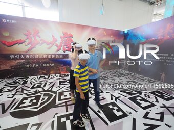 Visitors have a VR immersive movie-watching experience during the 2024 National Science Popularization Day in Beijing, China, on September 2...