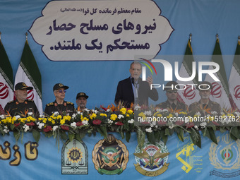 Iranian President Masoud Pezeshkian (C) speaks while standing next to Iranian army and IRGC commanders during a military parade commemoratin...