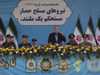 Iranian President Masoud Pezeshkian (C) speaks while standing next to Iranian army and IRGC commanders during a military parade commemoratin...