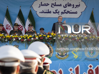 Iranian President Masoud Pezeshkian (C) speaks while standing next to Iranian army and IRGC commanders during a military parade commemoratin...