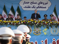 Iranian President Masoud Pezeshkian (C) speaks while standing next to Iranian army and IRGC commanders during a military parade commemoratin...