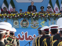 Iranian President Masoud Pezeshkian (C) speaks while standing next to Iranian army and IRGC commanders during a military parade commemoratin...