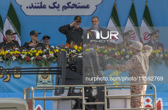 Commander of the Islamic Revolutionary Guard Corps' Ground Force, General Mohammad Pakpour (4thL), salutes while speaking with Iranian Presi...