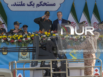 Commander of the Islamic Revolutionary Guard Corps' Ground Force, General Mohammad Pakpour (4thL), salutes while speaking with Iranian Presi...