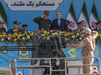 Commander of the Islamic Revolutionary Guard Corps' Ground Force, General Mohammad Pakpour (4thL), salutes while speaking with Iranian Presi...