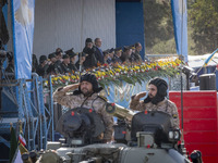 Commander of the Islamic Revolutionary Guard Corps' Ground Force, General Mohammad Pakpour (center L), salutes while speaking with Iranian P...