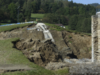 Firefighters inspect the damaged embankment of the Stronie Slaskie dam on the Morawka river in Stronie Slaskie, Poland on September 21, 2024...