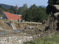 Firefighters inspect the damaged embankment of the Stronie Slaskie dam on the Morawka river in Stronie Slaskie, Poland on September 21, 2024...