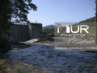 A dam with a damaged embankment that caused the heavy flooding of the town of Stronie Slaskie and other towns located downstream of the Mora...