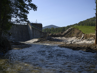 A dam with a damaged embankment that caused the heavy flooding of the town of Stronie Slaskie and other towns located downstream of the Mora...