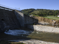 A dam with a damaged embankment that caused the heavy flooding of the town of Stronie Slaskie and other towns located downstream of the Mora...