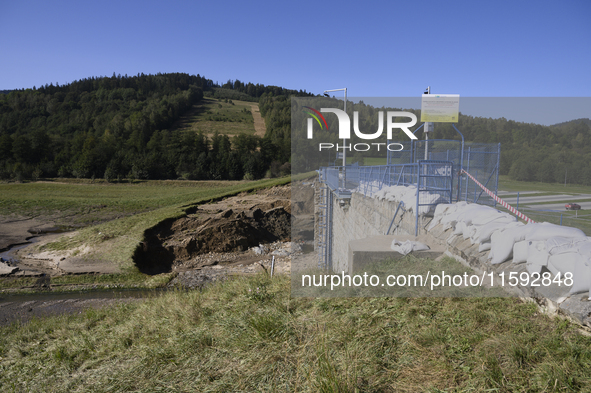 A dam with a damaged embankment that caused the heavy flooding of the town of Stronie Slaskie and other towns located downstream of the Mora...