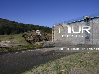 A dam with a damaged embankment that caused the heavy flooding of the town of Stronie Slaskie and other towns located downstream of the Mora...