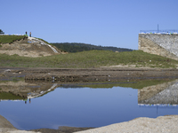 Firefighters inspect the damaged embankment of the Stronie Slaskie dam on the Morawka river in Stronie Slaskie, Poland on September 21, 2024...