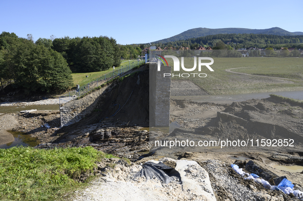 A dam with a damaged embankment that caused the heavy flooding of the town of Stronie Slaskie and other towns located downstream of the Mora...