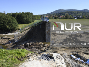 A dam with a damaged embankment that caused the heavy flooding of the town of Stronie Slaskie and other towns located downstream of the Mora...