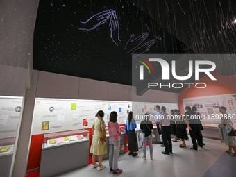 Visitors visit the Sign Language Museum at the Nanjing School for the Deaf in Nanjing, China, on September 21, 2024. (