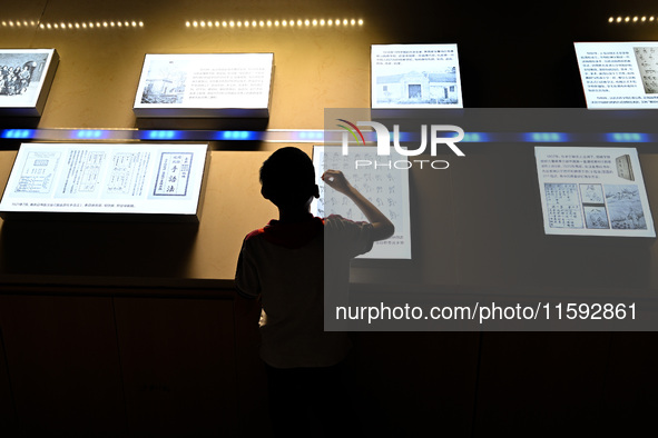 A child learns sign language at the Sign Language Museum at Nanjing School for the Deaf in Nanjing, China, on September 21, 2024. 