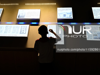 A child learns sign language at the Sign Language Museum at Nanjing School for the Deaf in Nanjing, China, on September 21, 2024. (