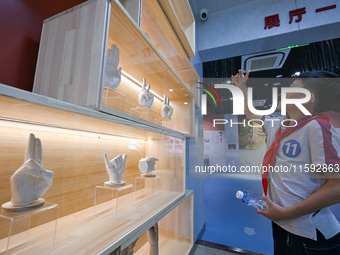 A child learns sign language at the Sign Language Museum at Nanjing School for the Deaf in Nanjing, China, on September 21, 2024. (