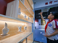 A child learns sign language at the Sign Language Museum at Nanjing School for the Deaf in Nanjing, China, on September 21, 2024. (