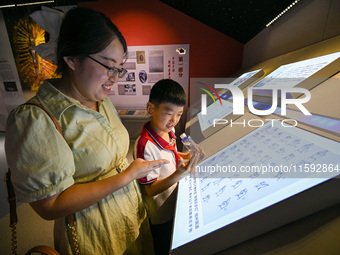 Parents learn sign language with their children at the Sign Language Museum at Nanjing School for the Deaf in Nanjing, China, on September 2...