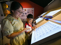 Parents learn sign language with their children at the Sign Language Museum at Nanjing School for the Deaf in Nanjing, China, on September 2...