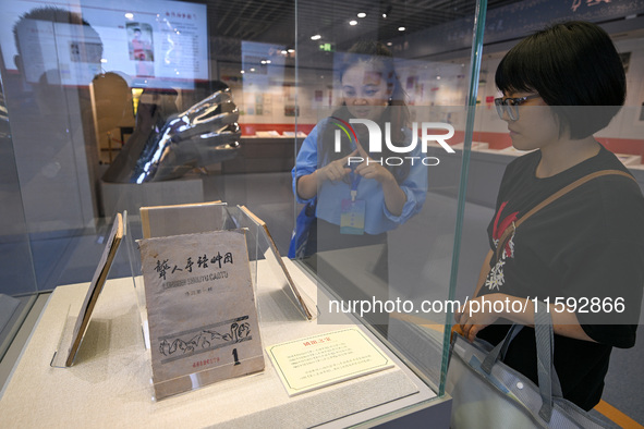 Visitors visit the Sign Language Museum at the Nanjing School for the Deaf in Nanjing, China, on September 21, 2024. 