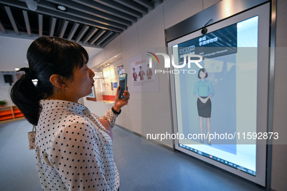 Visitors experience digital sign language translation at the Sign Language Museum at Nanjing School for the Deaf in Nanjing, China, on Septe...