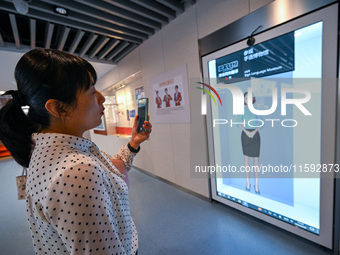 Visitors experience digital sign language translation at the Sign Language Museum at Nanjing School for the Deaf in Nanjing, China, on Septe...