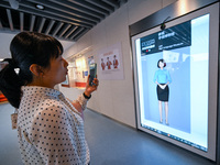 Visitors experience digital sign language translation at the Sign Language Museum at Nanjing School for the Deaf in Nanjing, China, on Septe...