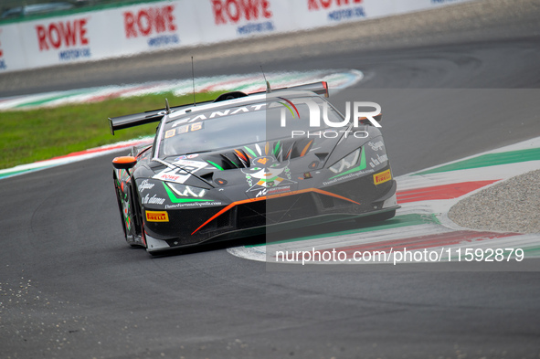 Antoine Doquin, Till Bechtolsheimer, and Sandy Mitchell of team Barwell Motorsport stand next to a Lamborghini Huracan GT3 EVO 2 GT car on a...