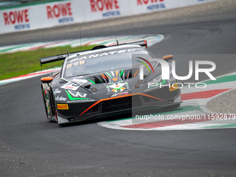 Antoine Doquin, Till Bechtolsheimer, and Sandy Mitchell of team Barwell Motorsport stand next to a Lamborghini Huracan GT3 EVO 2 GT car on a...