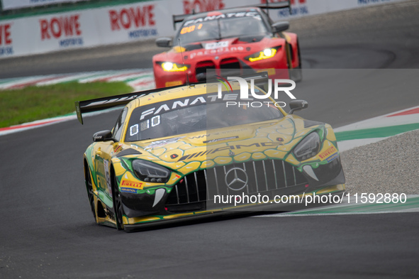 Maro Engel, Daniel Morad, and Lucas Auer of the Mercedes-AMG Team MANN-Filter stand next to a Mercedes-AMG GT3 EVO GT car on a pit lane duri...