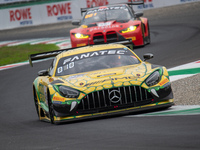 Maro Engel, Daniel Morad, and Lucas Auer of the Mercedes-AMG Team MANN-Filter stand next to a Mercedes-AMG GT3 EVO GT car on a pit lane duri...