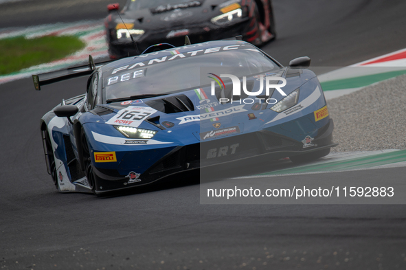 Franck Perera, Marco Mapelli, and Jordan Pepper of the GRT - Grasser Racing Team stand next to a Lamborghini Huracan GT3 EVO2 GT car on a pi...