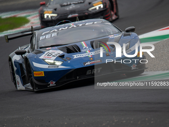 Franck Perera, Marco Mapelli, and Jordan Pepper of the GRT - Grasser Racing Team stand next to a Lamborghini Huracan GT3 EVO2 GT car on a pi...