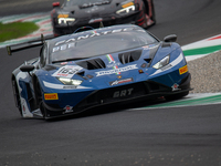 Franck Perera, Marco Mapelli, and Jordan Pepper of the GRT - Grasser Racing Team stand next to a Lamborghini Huracan GT3 EVO2 GT car on a pi...