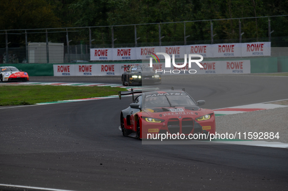 Darren Leung, Toby Sowery, and Jake Dennis of Team Century Motorsport stand next to a BMW M4 GT3 GT car on a pit lane during the Fanatec GT...