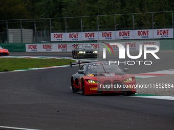 Darren Leung, Toby Sowery, and Jake Dennis of Team Century Motorsport stand next to a BMW M4 GT3 GT car on a pit lane during the Fanatec GT...