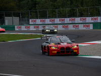 Darren Leung, Toby Sowery, and Jake Dennis of Team Century Motorsport stand next to a BMW M4 GT3 GT car on a pit lane during the Fanatec GT...