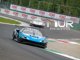 Nicolo Rosi, Niccolo Schiro, and David Fumanelli of team Kessel Racing stand next to a Ferrari 296 GT3 GT car on a pit lane during the Fanat...